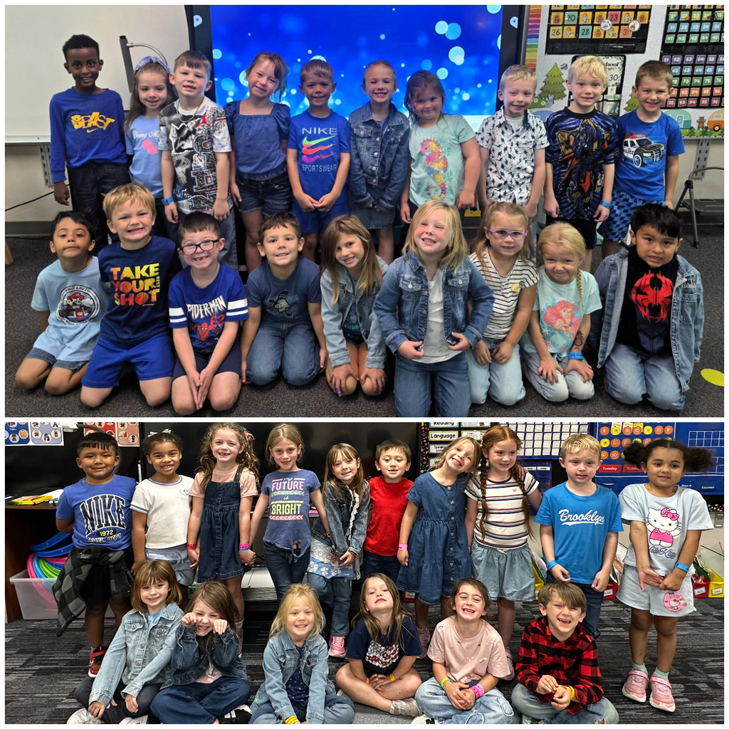Classroom of students dressed in denim or blue smiling for a group picture.