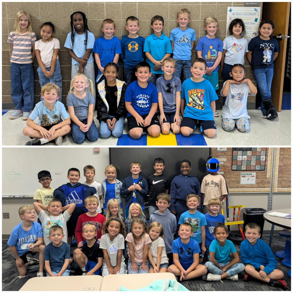 Classroom of students dressed in denim or blue smiling for a group picture.