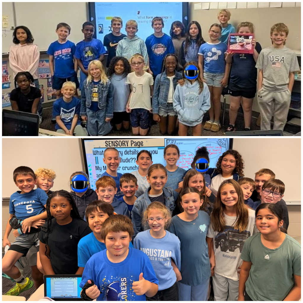 Classroom of students dressed in denim or blue smiling for a group picture.