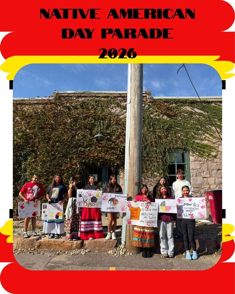 Nine Edison Middle School students stand outdoors holding handmade posters celebrating Indigenous peoples and Native American Day. Several posters feature colorful handprints, Indigenous symbols, and messages of remembrance and justice.