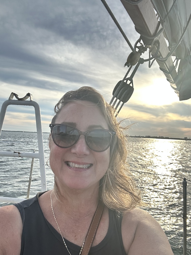 Mrs. Jibben on a boat on the water.