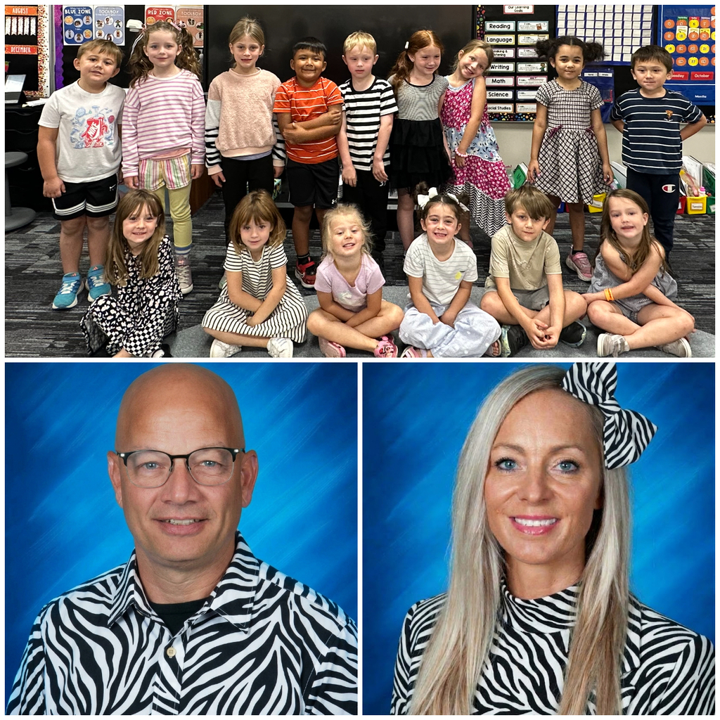 Classroom group photo of students and staff dressed in zebra stripes or black and white for homecoming dress up days.
