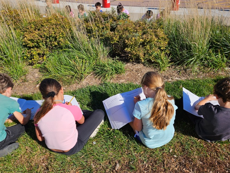 students writing in their science journal