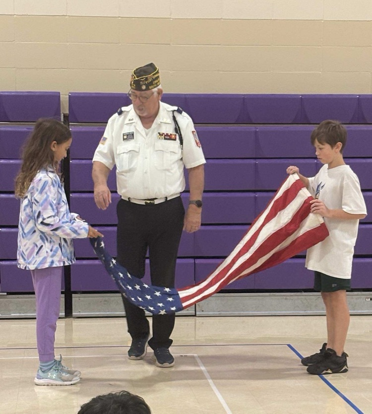 children begin to fold united states flag