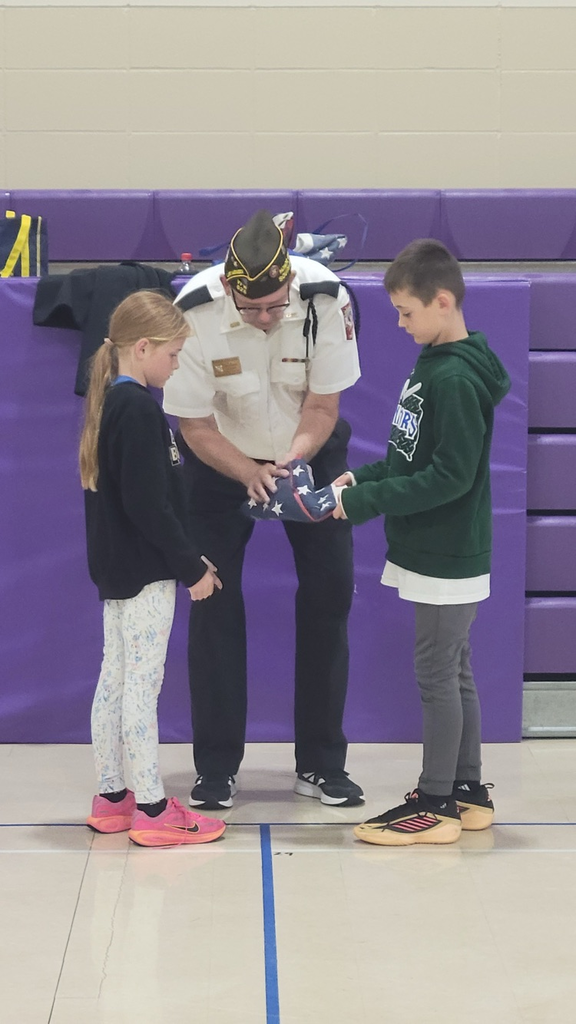 children completely fold up the United States flag 