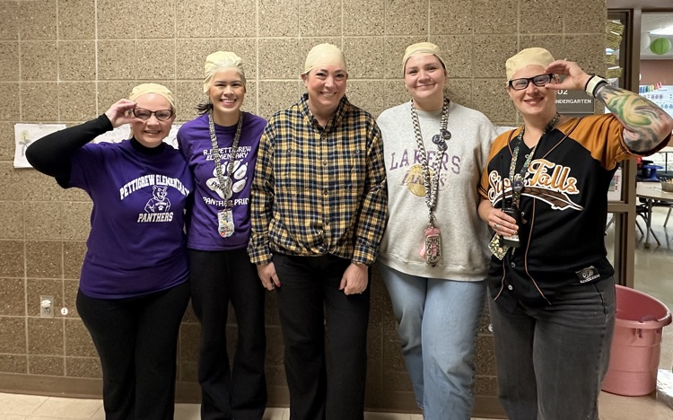 staff members dress up like our principal wearing bald head wigs