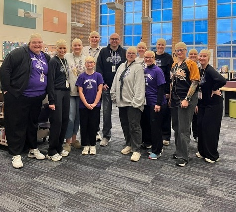 staff members all wearing bald wigs to look like our principal 
