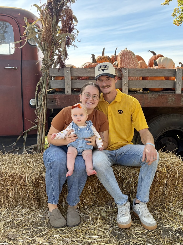 Mrs.Nickerson with her baby and husband at the pumpkin patch