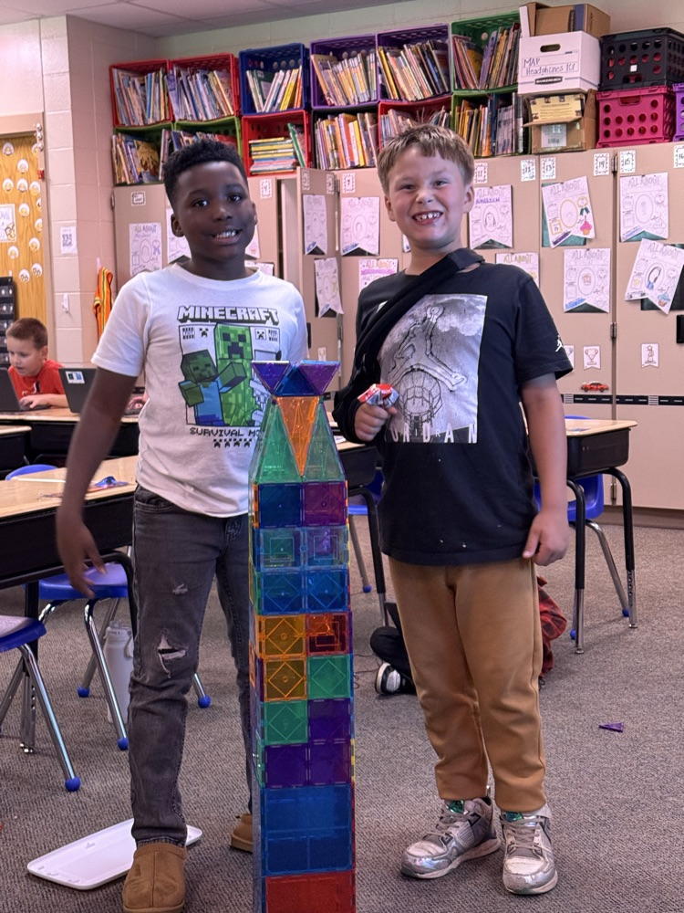 two students with magna tile tower