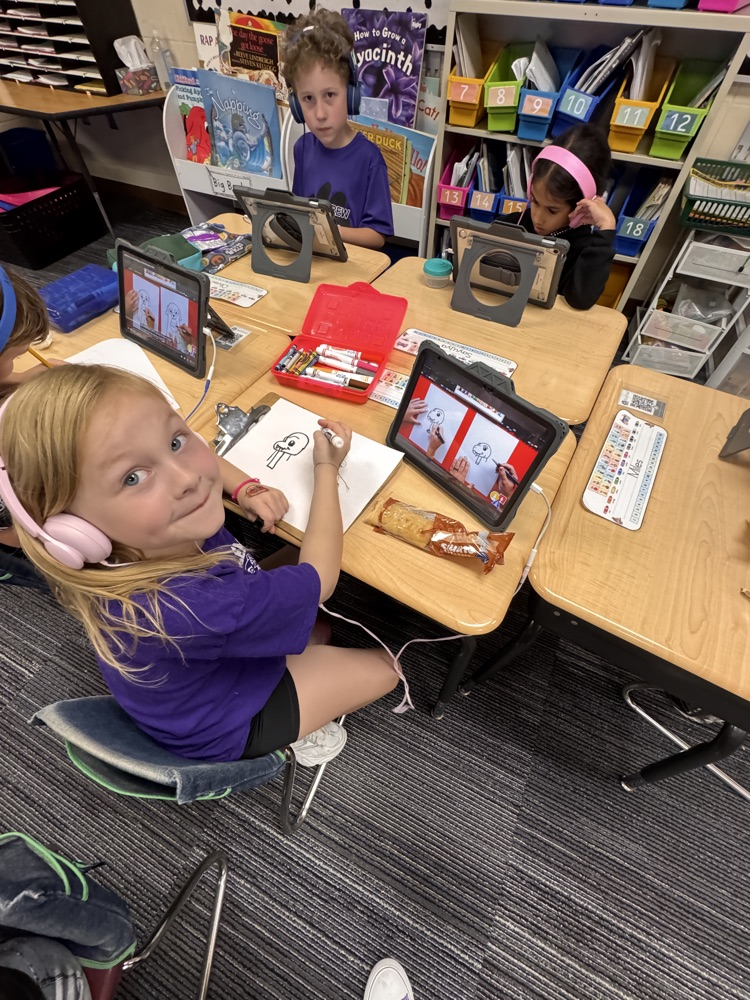 students enjoying snack time and free time while listening to a story on a device 
