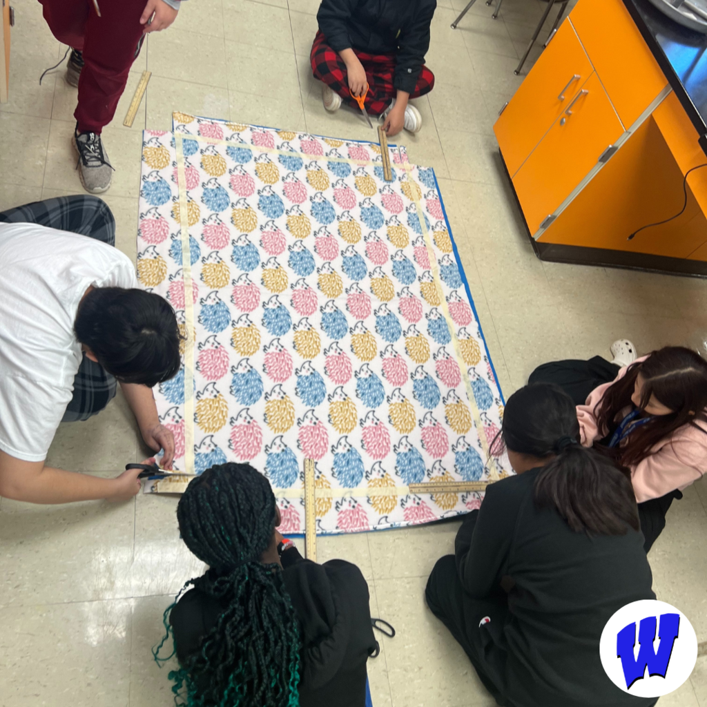 Whittier students creating a blanket for Project Warm-Up
