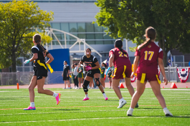 Washington and Roosevelt High School Girls Flag Football players run with a ball on the turf at Howard Wood Field at the very first Girls Flag Football Jamobree