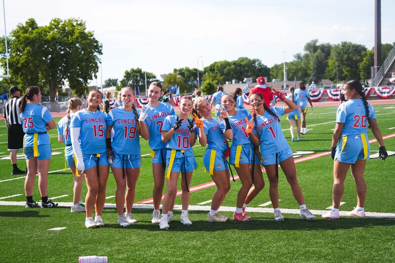 Lincoln High School Girls Flag Football members happily pose together at the very first Girls Flag Football Jamboree event at Howard Wood Field