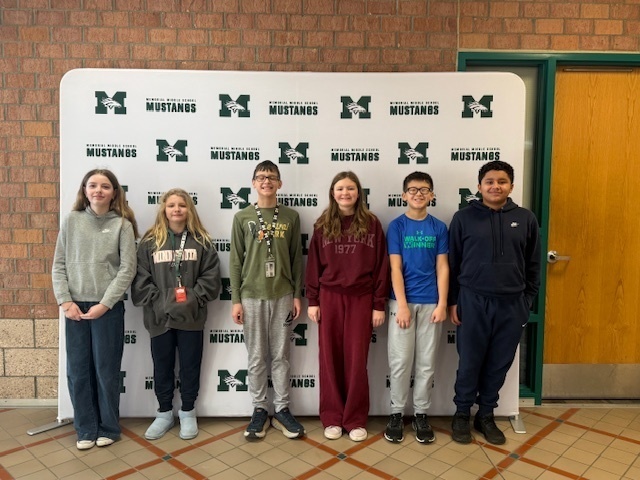 Six 6th grade Students of the Month standing in front of the Mustang backdrop.