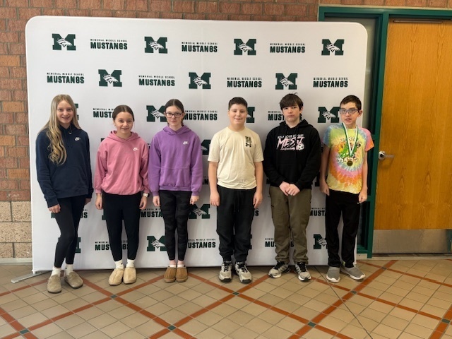 Six 7th grade Students of the Month standing in front of the Mustang backdrop.