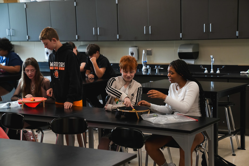 Students in 6th grade science class do an experiment