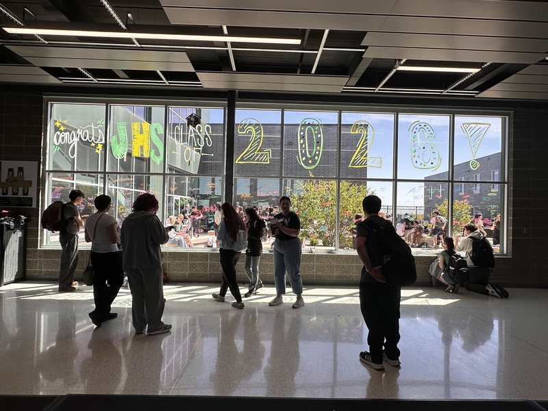 Class of 2026 signing the front windows at JHS