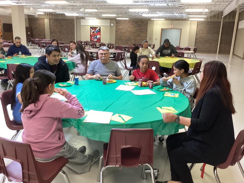 5th Grade students enjoying pizza.
