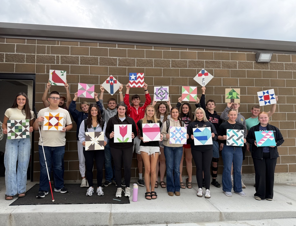 Pictures of students holding their barn quilts