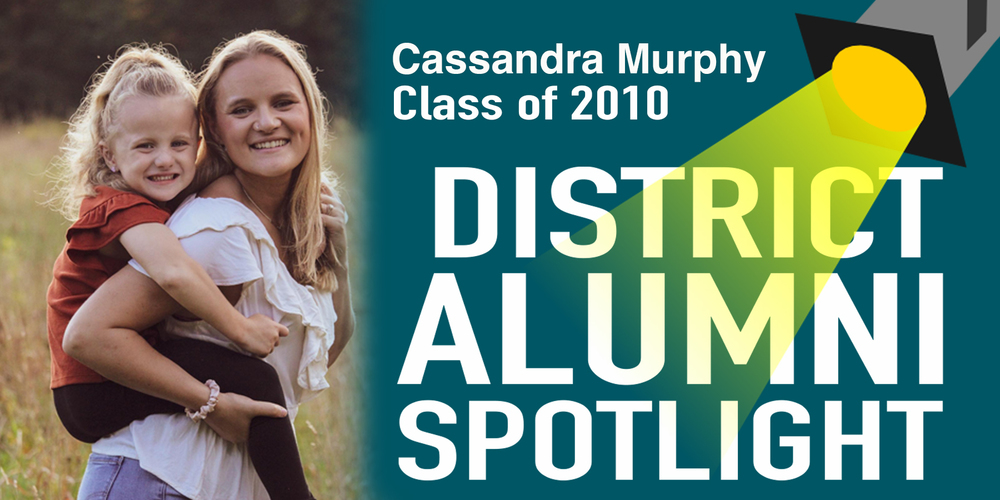 Graphic promoting a District Alumni Spotlight featuring Cassandra Murphy, Fair Haven Union High School Class of 2010. The design shows Cassandra smiling outdoors while holding a young child on her back, with text reading “Cassandra Murphy Class of 2010” and “District Alumni Spotlight,” alongside a spotlight illustration on a teal background.