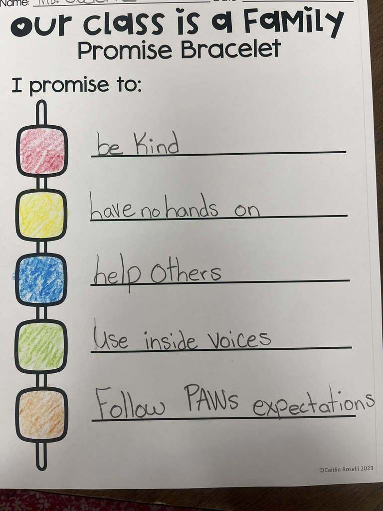 "First graders displaying bracelets they made, each representing a classroom expectation."