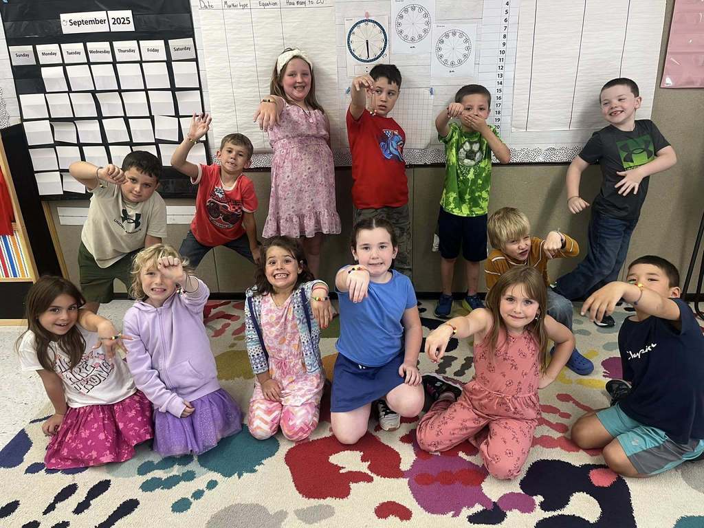 "First graders displaying bracelets they made, each representing a classroom expectation."