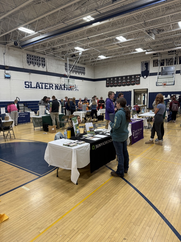 Students and representatives gather at tables during a career and college fair inside the Slater Nation gym, with booths including SUNY Adirondack and Middlebury College.