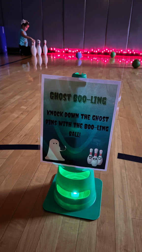 A green cone with a “Ghost Boo-ling” sign sits near bowling pins and balls; a student sets up pins under pink lights.