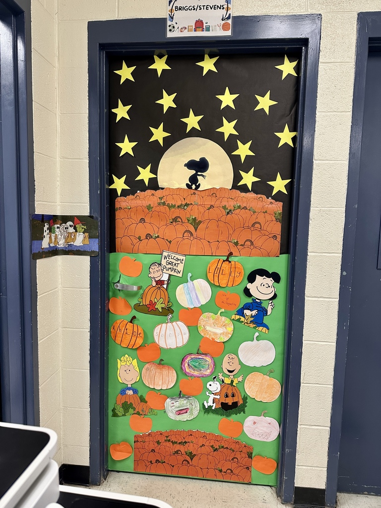 Door decorated with a Peanuts “Great Pumpkin” theme, featuring Snoopy, Linus, and pumpkins under a night sky of stars.