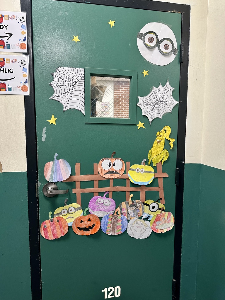 A green door decorated with Minion-themed pumpkins, stars, spider webs, and paper cutouts.