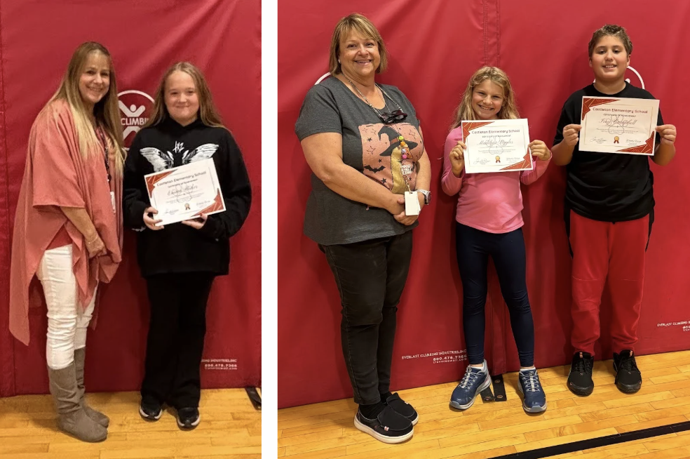 Student holding a certificate stands with an adult in front of a red gym mat.  and Two students and an adult standing together; both students hold certificates in front of a red gym mat.