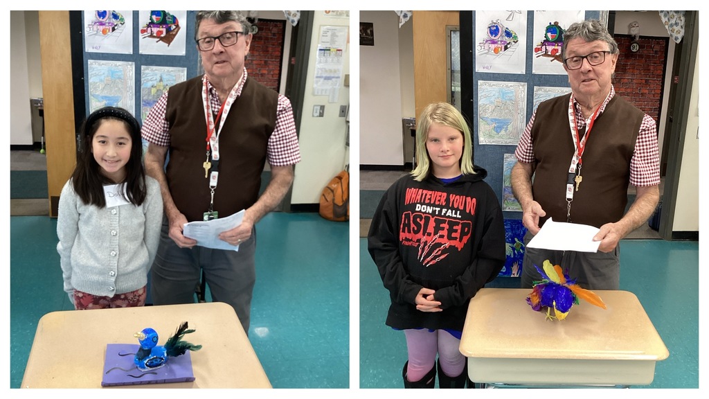 Alt text (left): A student stands beside her blue bird project displayed on a desk while the teacher stands next to her holding papers. Alt text (right): A student stands beside her multicolored bird project displayed on a desk while the teacher stands next to her holding papers.