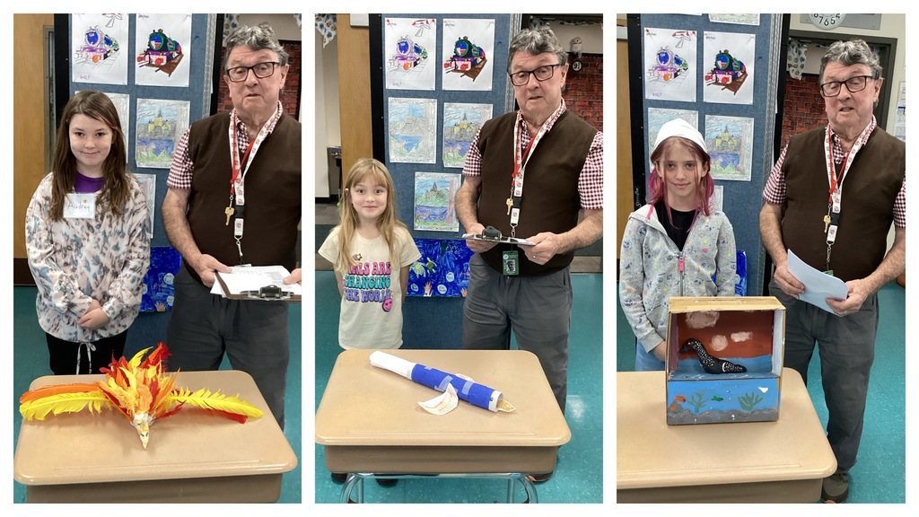 Alt text (left): A student stands with her orange-and-yellow flame-themed bird project on a desk next to the teacher. Alt text (middle): A student stands with her blue-and-white rolled-paper bird next to the teacher. Alt text (right): A student stands with her painted shoebox bird diorama next to the teacher.