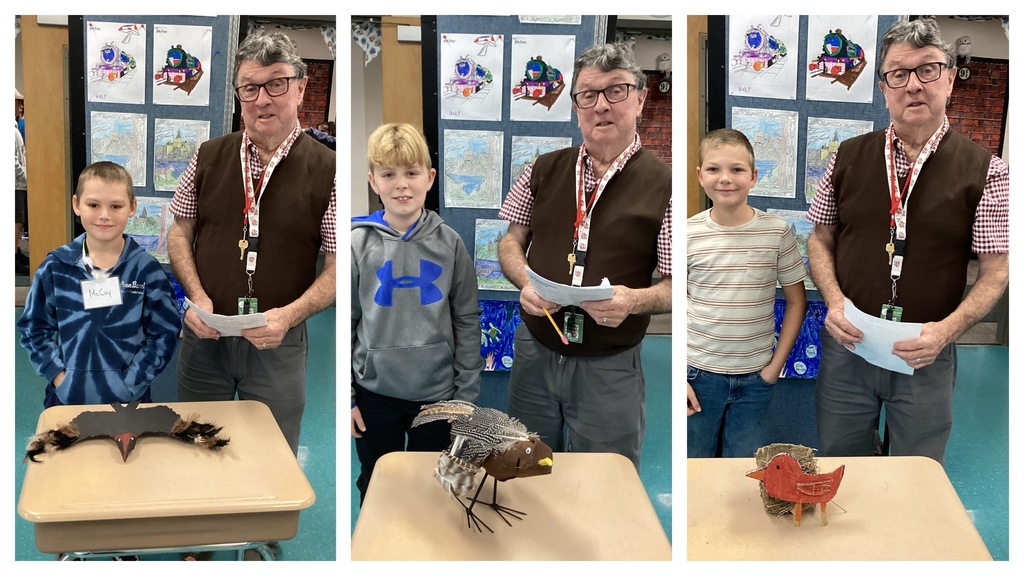 Alt text (left): A student stands beside his black wide-winged bird project on a desk next to the teacher. Alt text (middle): A student stands with his brown feathered bird project on a desk next to the teacher. Alt text (right): A student stands beside his red bird-in-a-nest project on a desk next to the teacher.