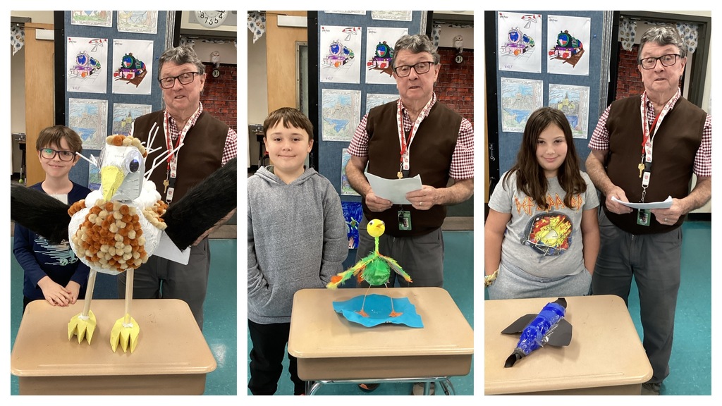 Alt text (left): A student poses with a large pom-pom-covered bird sculpture on a desk next to the teacher. Alt text (middle): A student stands with a tall, green, long-legged bird model on a desk next to the teacher. Alt text (right): A student stands with her blue-and-gray bottle-constructed bird on a desk next to the teacher.