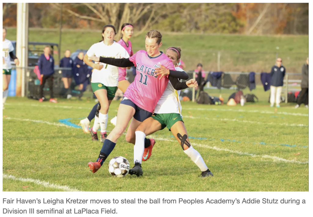 photograph from a soccer match showing two players closely contesting the ball on a grass field. Fair Haven's Leigha Kretzer (wearing a pink jersey with 'SLATERS 11') is shielded by a Peoples Academy player, Addie Stutz (wearing a white and green jersey). Kretzer is moving to steal the ball. The caption reads: 'Fair Haven's Leigha Kretzer moves to steal the ball from Peoples Academy's Addie Stutz during a Division III semifinal at LaPlaca Field.