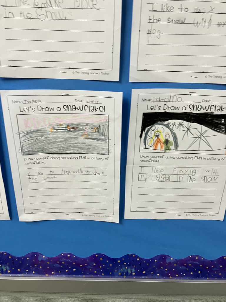 A bulletin board displays six children's winter-themed worksheets titled “Let’s Draw a Snowflake!” Each page includes a colorful drawing of a child doing a fun activity in the snow—such as sledding, playing with a pet, or making igloos—along with simple handwritten sentences describing the activity. The artwork features bright colors, stick figures, snowflakes, and winter scenes. The worksheets are arranged in two rows of three on a blue background.