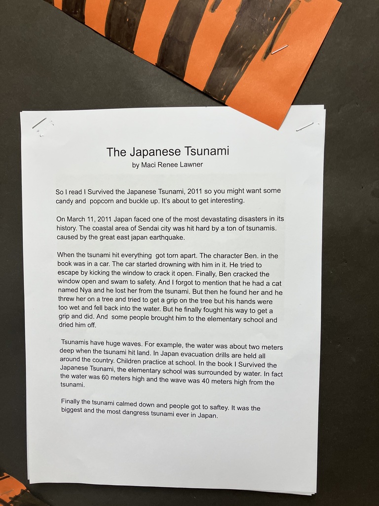 A printed report titled "The Japanese Tsunami" . The text describes the 2011 disaster, mentioning a book called I Survived the Japanese Tsunami, 2011 and facts about evacuation drills and wave heights.