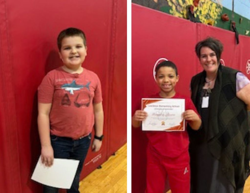 A student holds a certificate next to a staff member in a school gym, both smiling in front of red safety mats.