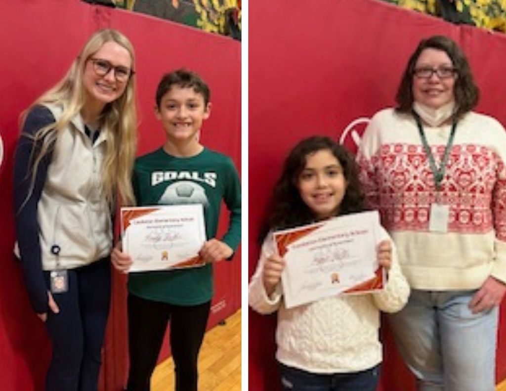 Two students display certificates while standing with a staff member in a gymnasium, smiling in front of red padding.