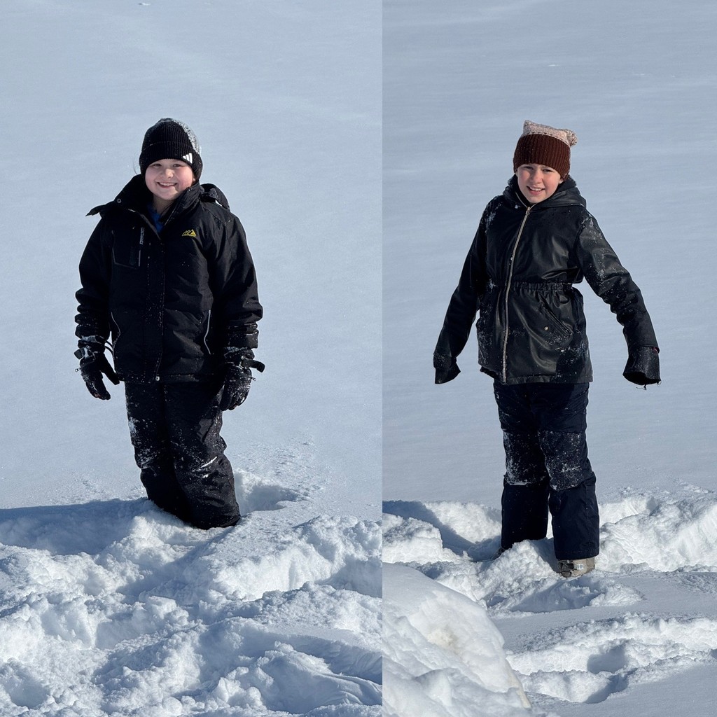 A side-by-side composite shows two children in dark winter gear standing in a vast, flat snow-covered field. The child on the left wears a black jacket and beanie, while the child on the right wears a black jacket and a brown knit hat.