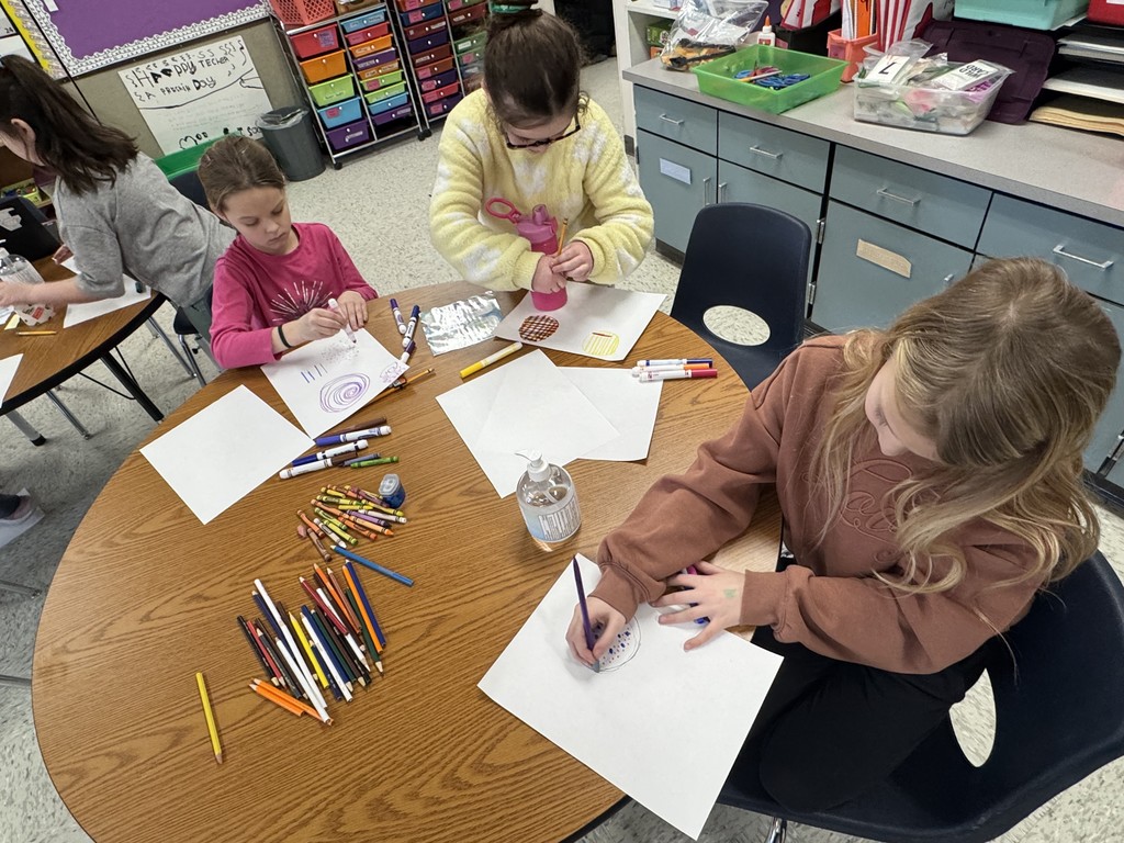 others work on pieces featuring geometric patterns, swirls, and landscape elements.