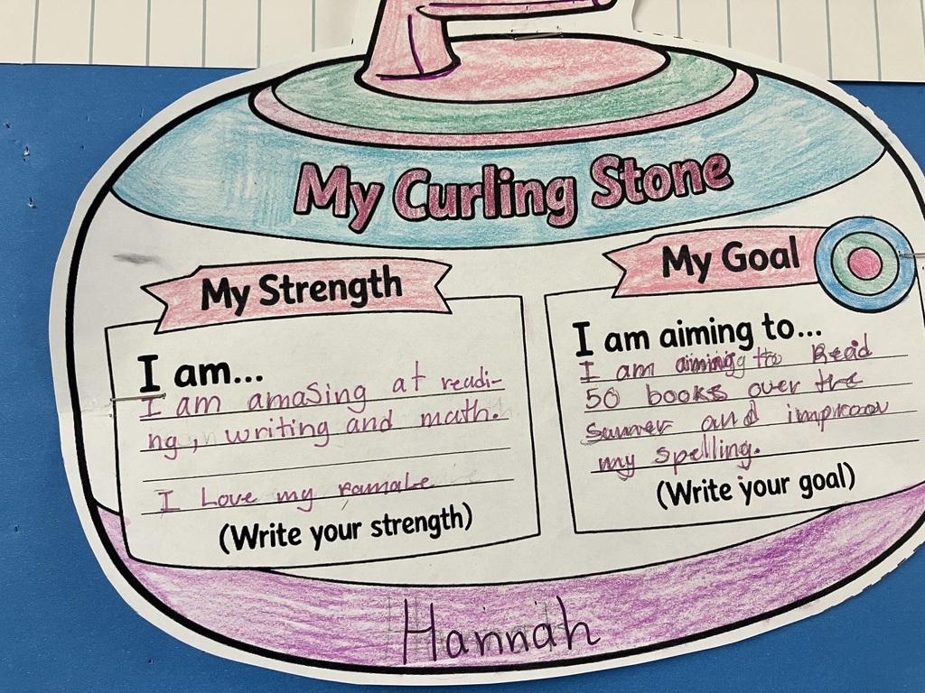 Gemini said This photo features a hand-colored paper cutout of a curling stone from a student project, pinned to a blue background. The stone is colored with purple and light blue crayons, and the name "Hannah" is written in purple marker at the bottom.  The cutout is divided into two sections:  My Strength: "I am... amazing at reading, writing and math. I Love my famale [family]."  My Goal: "Read 50 books over the Summer and and improve am lis [on his] Spelling."