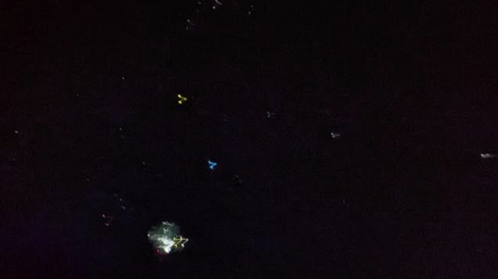 Dark image of a projected night sky showing stars and constellation shapes during a planetarium presentation.