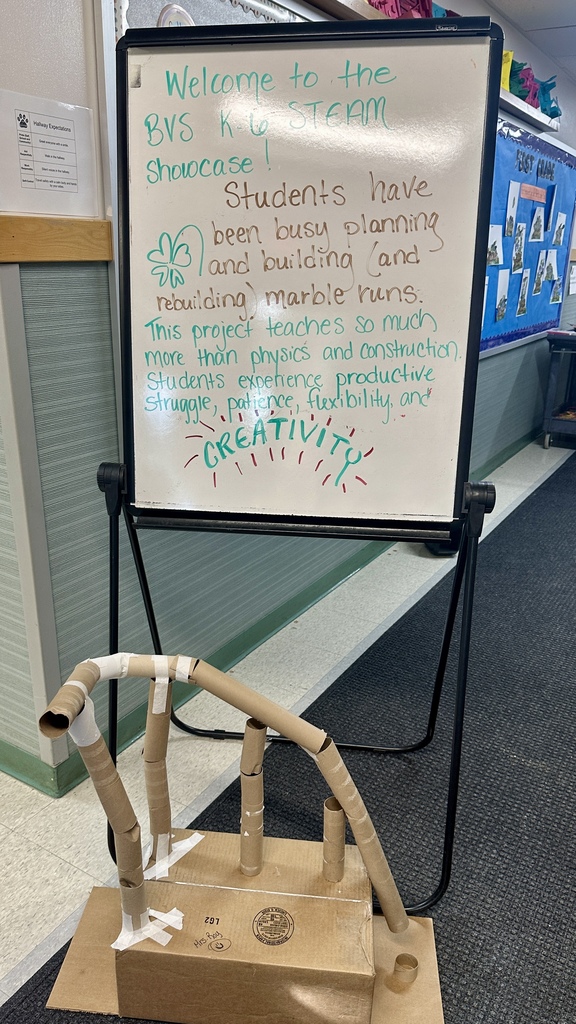 A whiteboard sign reads “Welcome to the BVS K-6 STEAM Showcase” with a description of the marble run project, next to a sample cardboard marble run display.