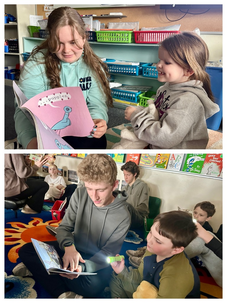 A high school student reads with a young child seated in a chair, both focused on a book during one-on-one reading time.