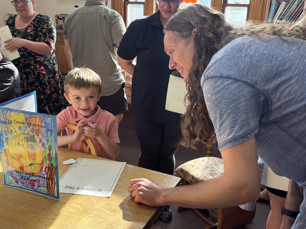 FHGS first graders gather for a group photo at the Fair Haven Free Library, proudly holding their handmade books and displaying their work as young authors.