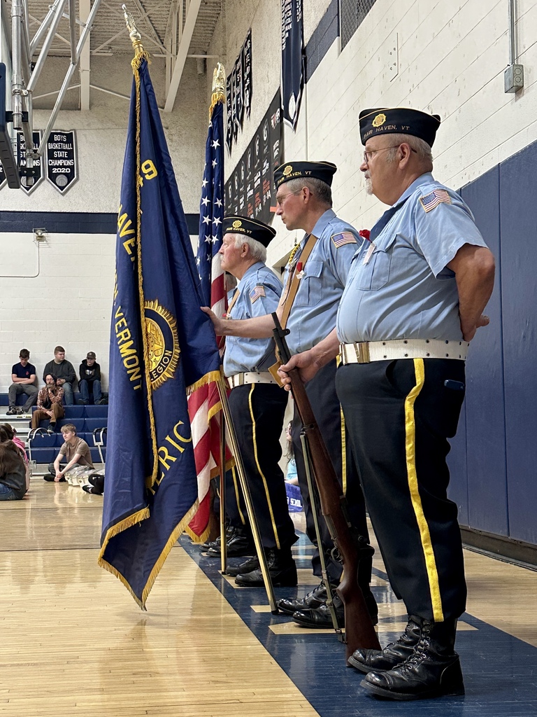 Members of the Fair Haven American Legion Post 49 Color Guard stand in formation holding flags and ceremonial rifles during the Memorial Day program.