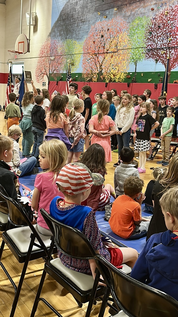 Members of the Crippen-Fellows Post 50 Color Guard stand in formation holding the American flag and ceremonial flags during the Memorial Day assembly.