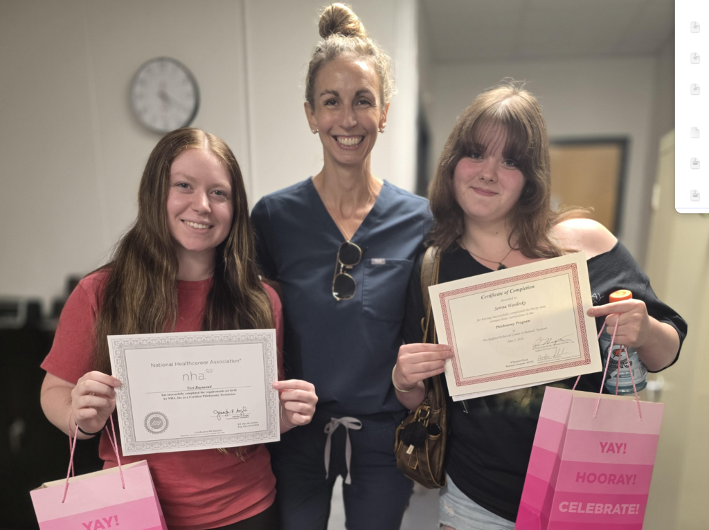 Newly certified Phlebotomists Tori Raymond and Serena Wasilesky stand beside their instructor Andrea Sheehan.